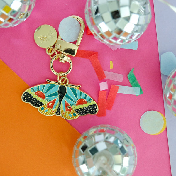 611fc05e3c4ce80992caae23_cosmicmoth-enamelkeychain-lifestyle-01_1790897078433.jpg